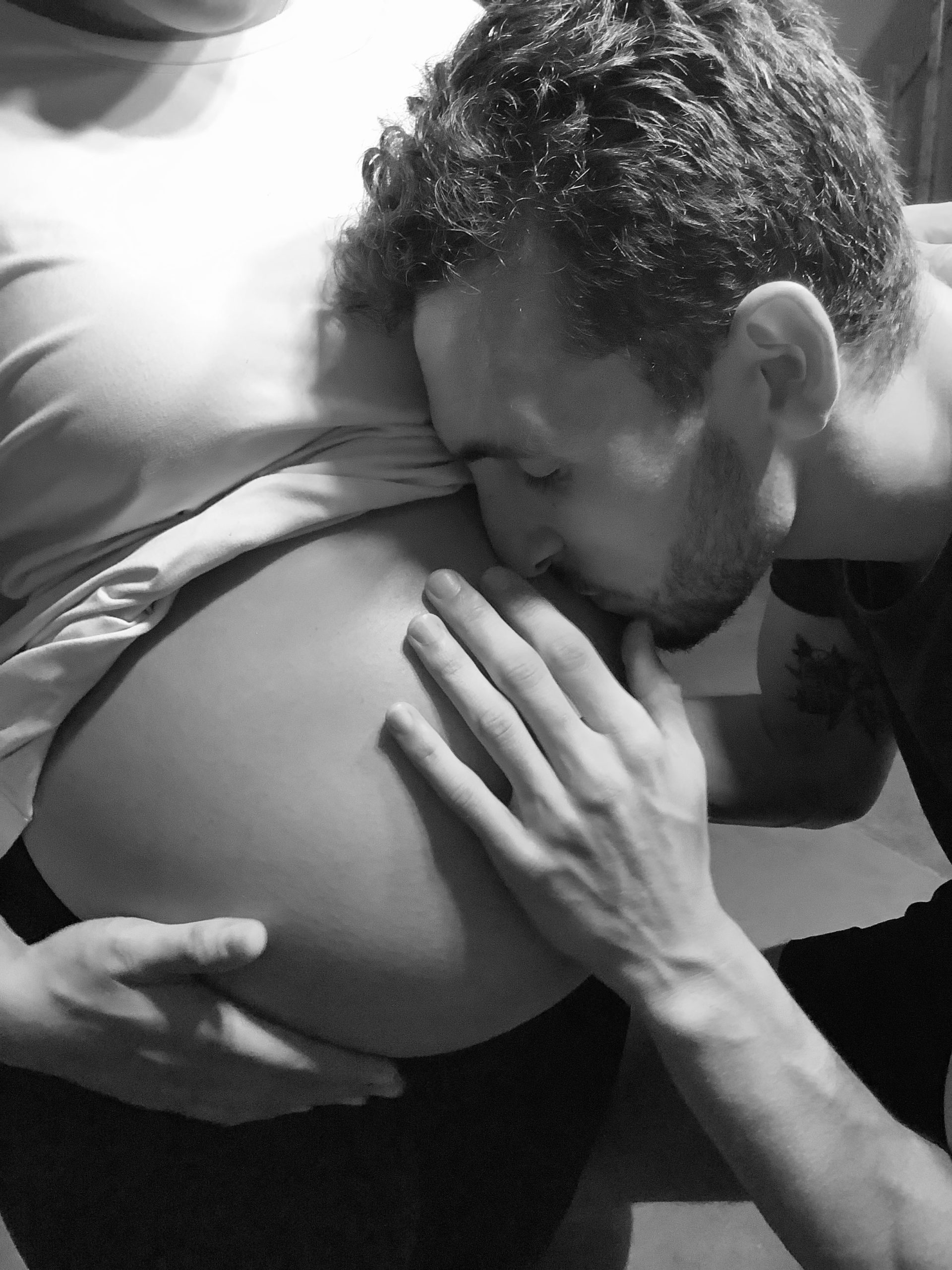 man kissing woman's stomach